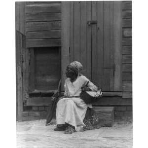  African American woman on step,holding basket,New Orleans 