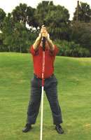   arms out straight in front of you Place bottom of pole where the ball